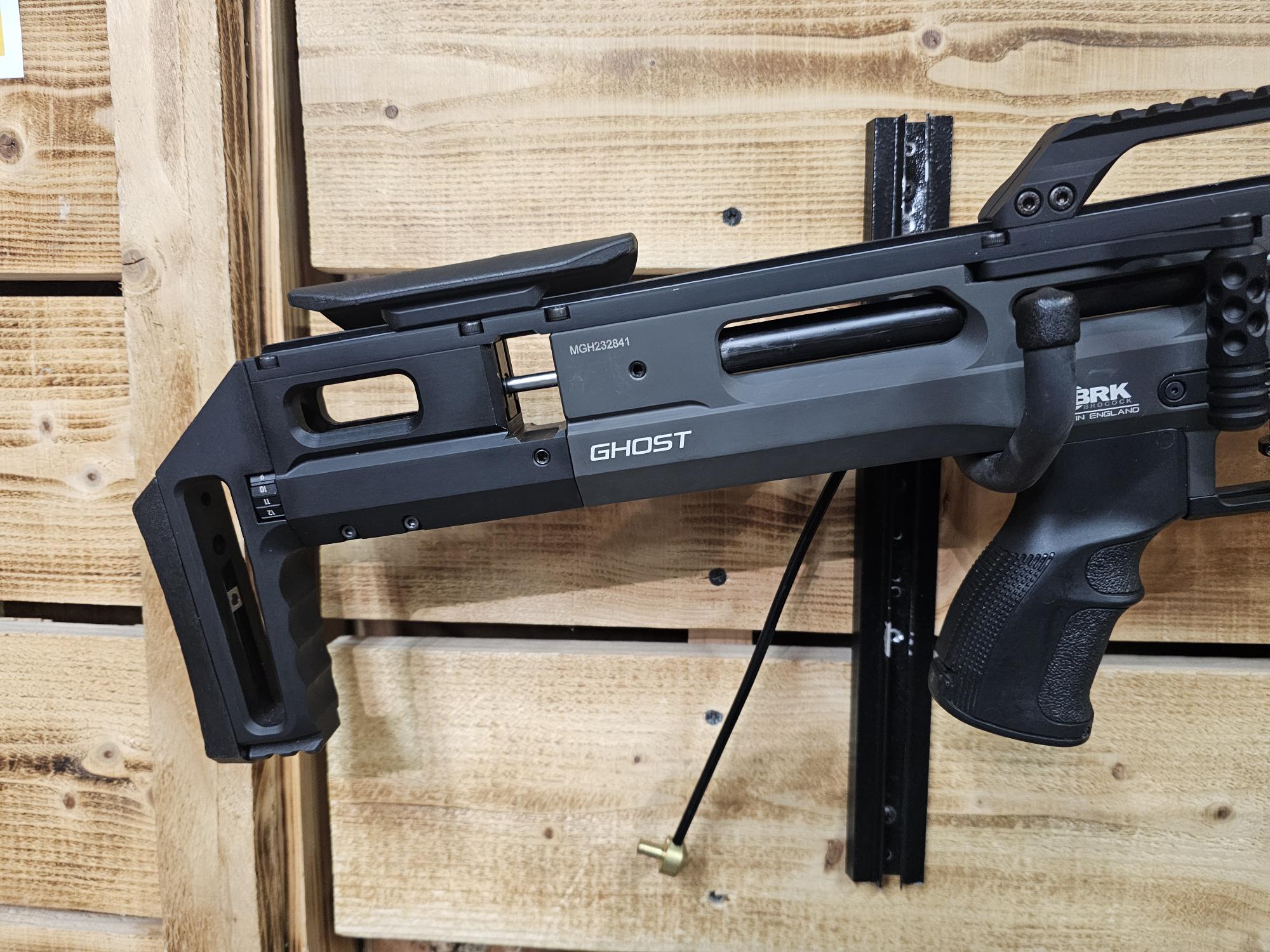 Ghost air gun model displayed on a wooden background with a visible stock and grip.